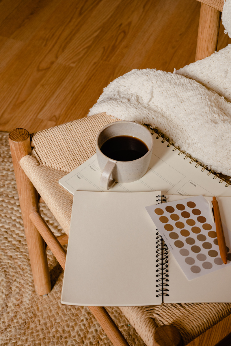 Coffee, Notebooks and Stickers on Wooden Chair 